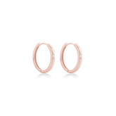 Fine jewellery, silver jewellery plated with rose gold, hypoallergenic, tarnish-free, close-up right view of Rose gold hoop earrings on a white background